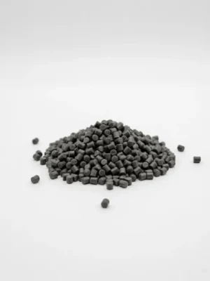 Small dark cylindrical weather-resistant anti-aging color masterbatch pellets on a clean white background