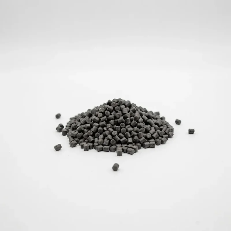 Small dark cylindrical weather-resistant anti-aging color masterbatch pellets on a clean white background